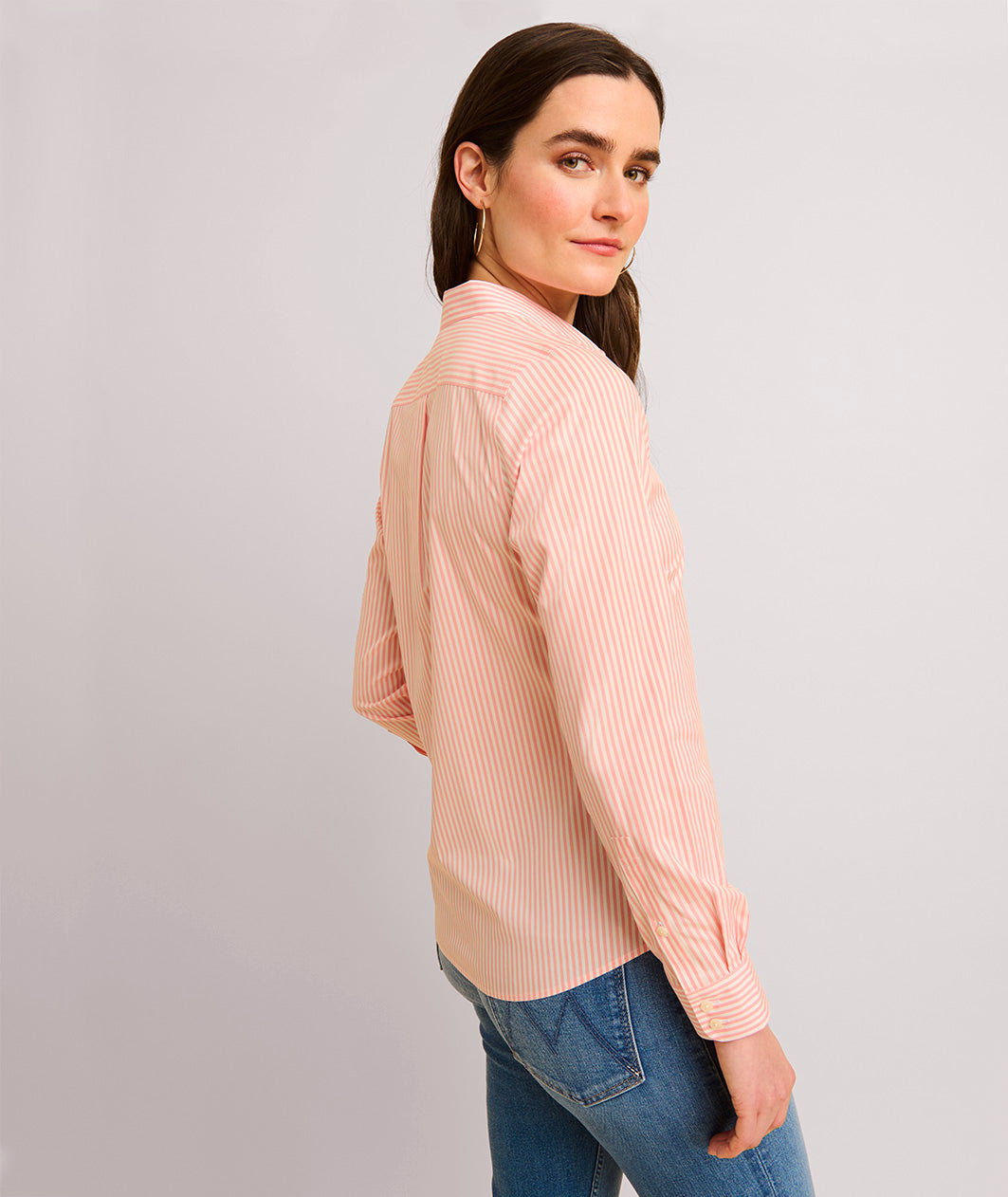 Model is wearing UNTUCKit Bella pink stripe shirt.