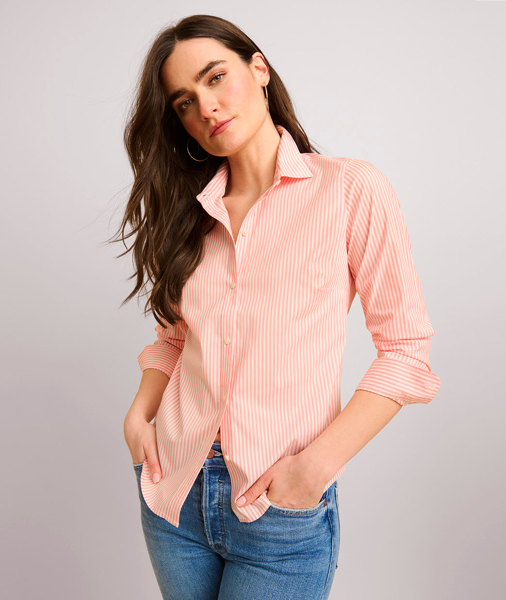 Model is wearing UNTUCKit Bella pink stripe shirt.