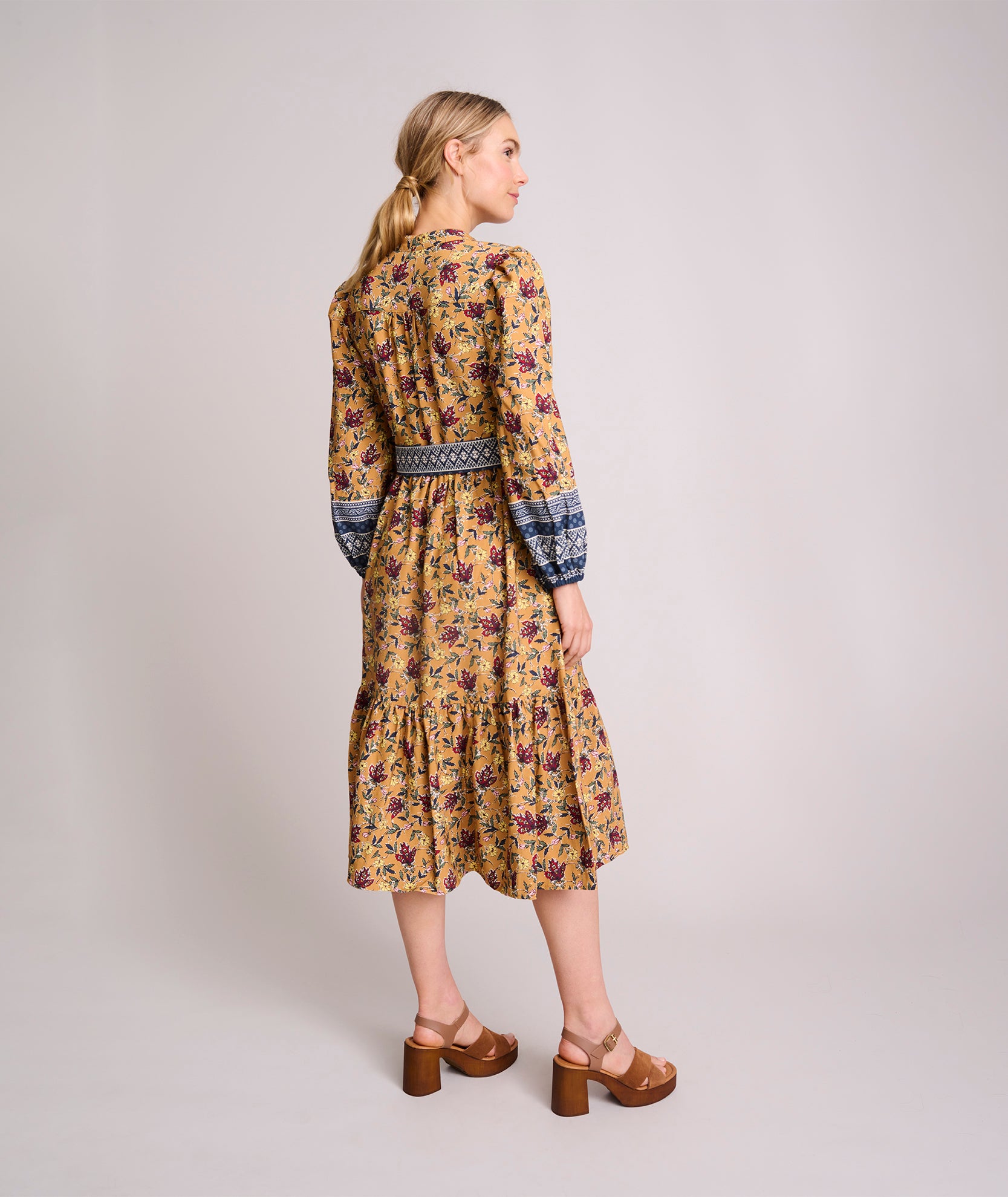 Model is wearing UNTUCKit Soft Twill Floral Border Print Flora Dress. 