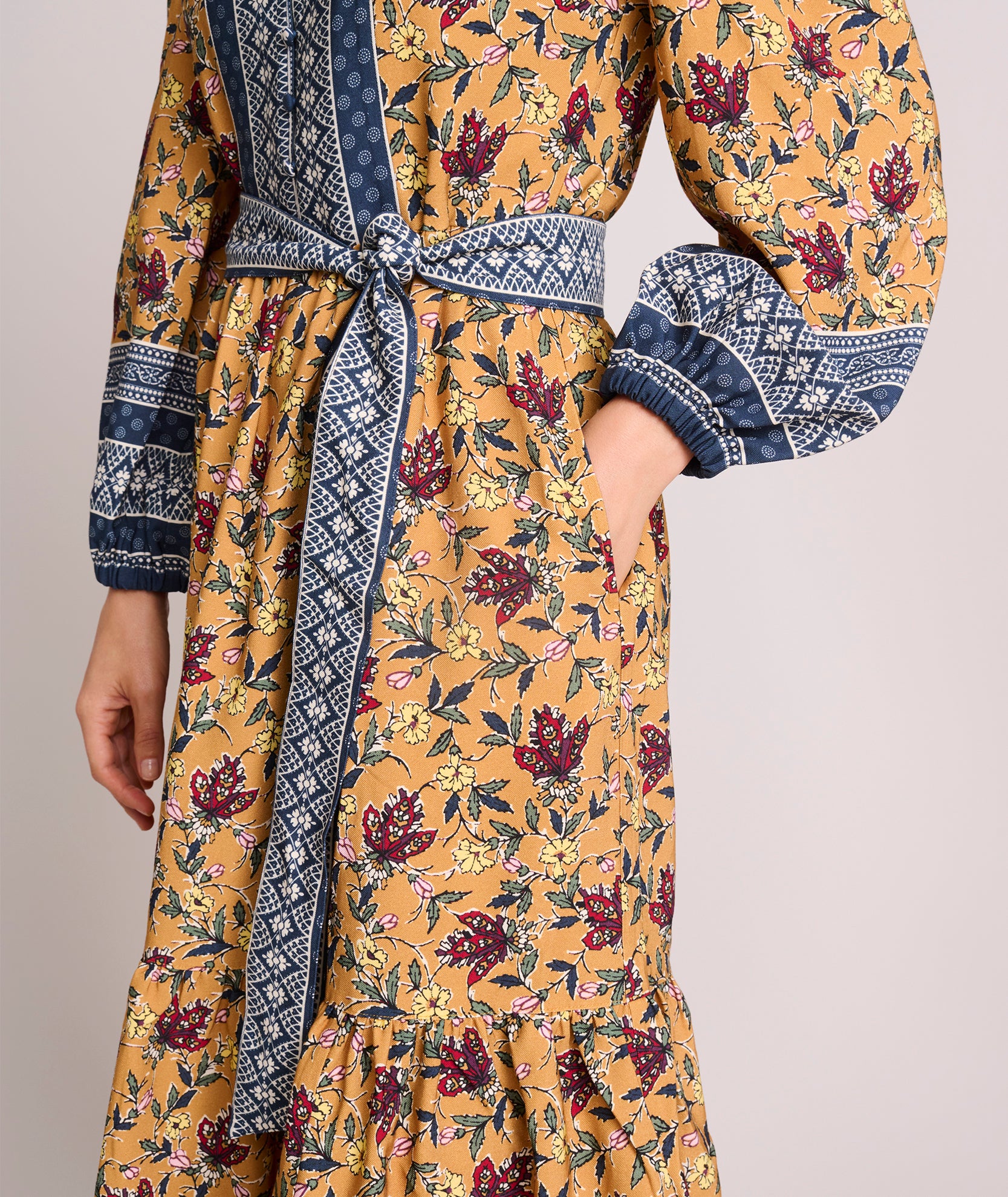 Model is wearing UNTUCKit Soft Twill Floral Border Print Flora Dress. 