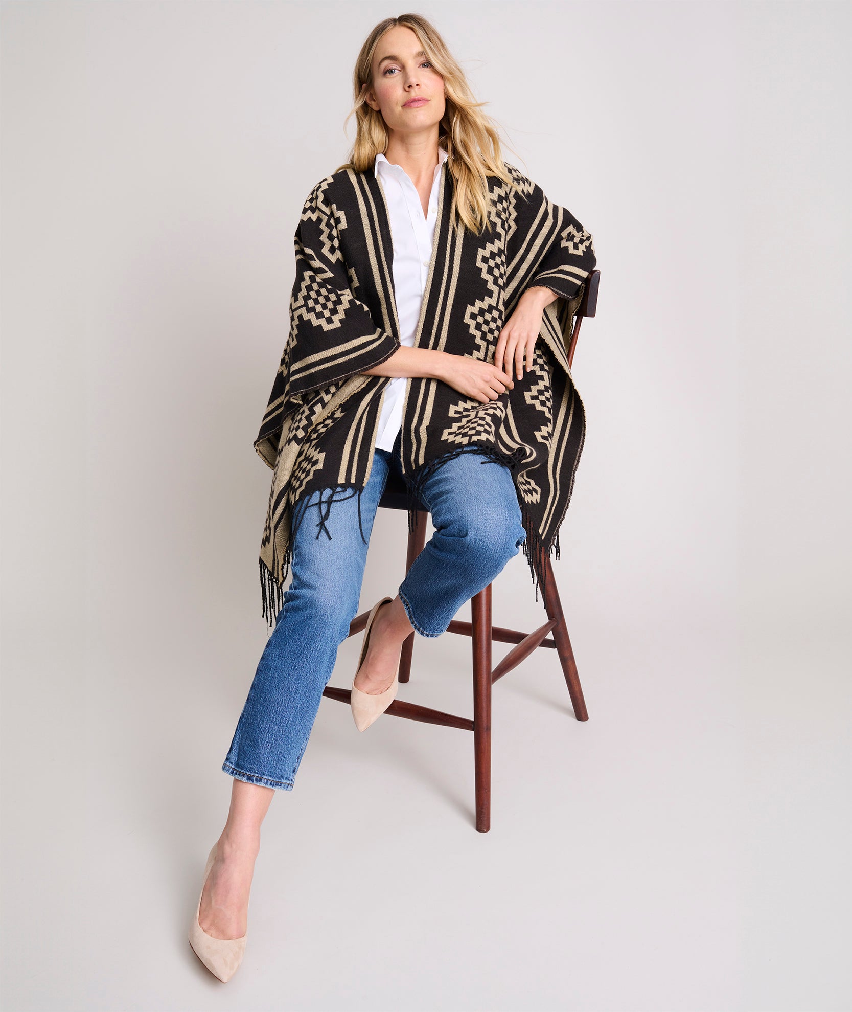 Model is wearing UNTUCKit Fringe Trim Geo Print Poncho.