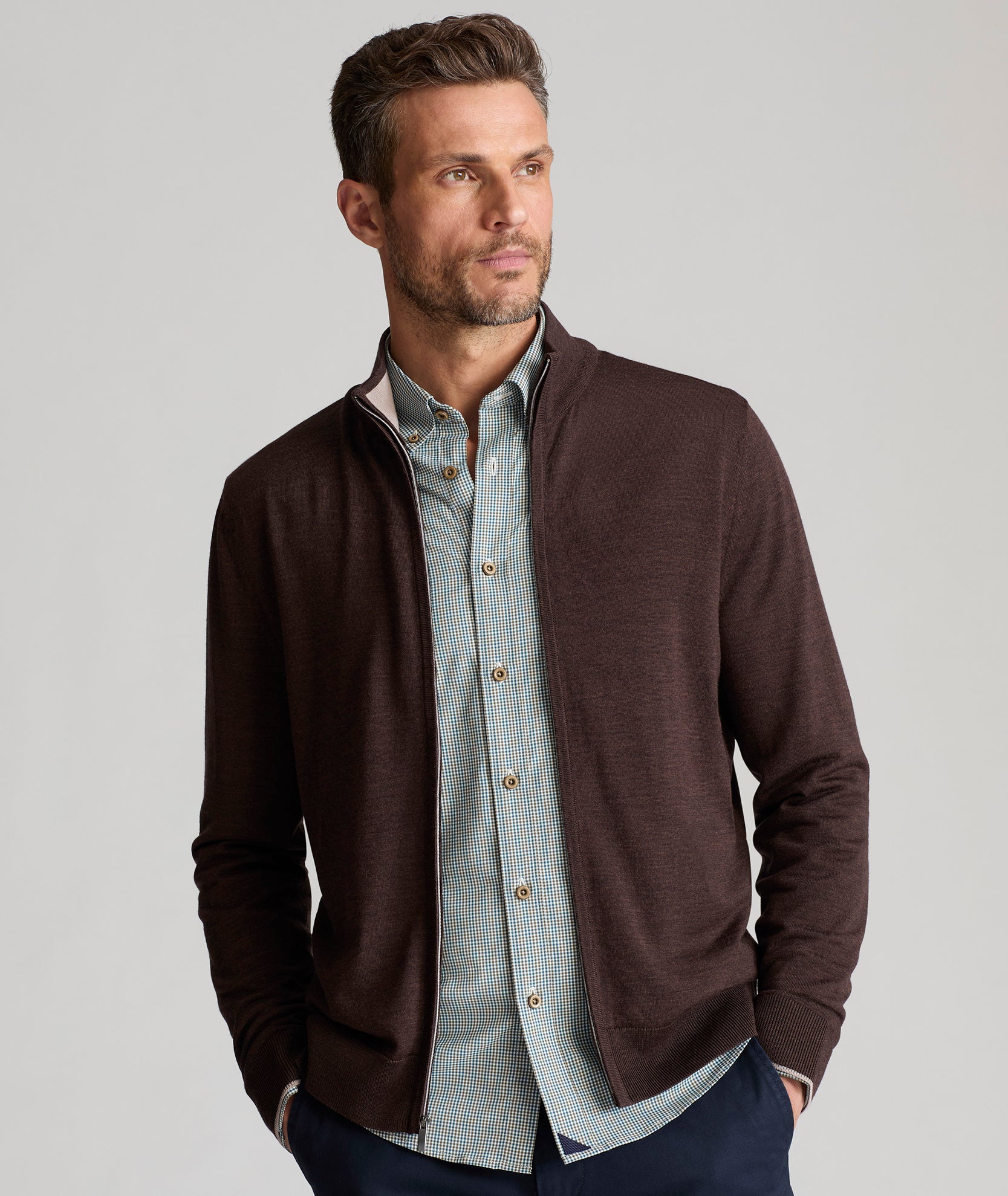 Model is wearing UNTUCKit Alston Full-Zip sweater in Dark Brown.