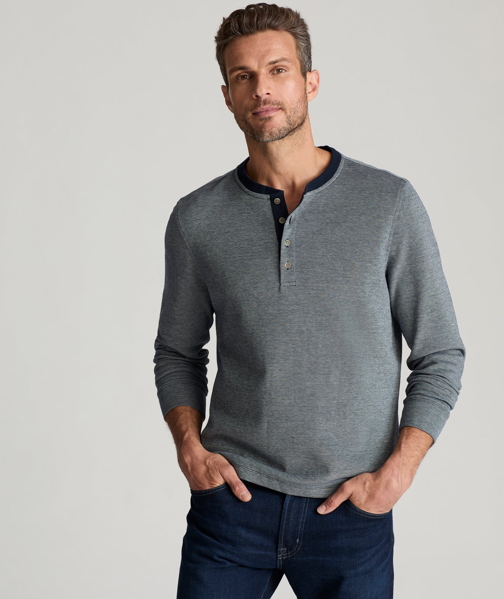 Model is wearing UNTUCKit Cascudo long sleeve pique henley in sky Captain.