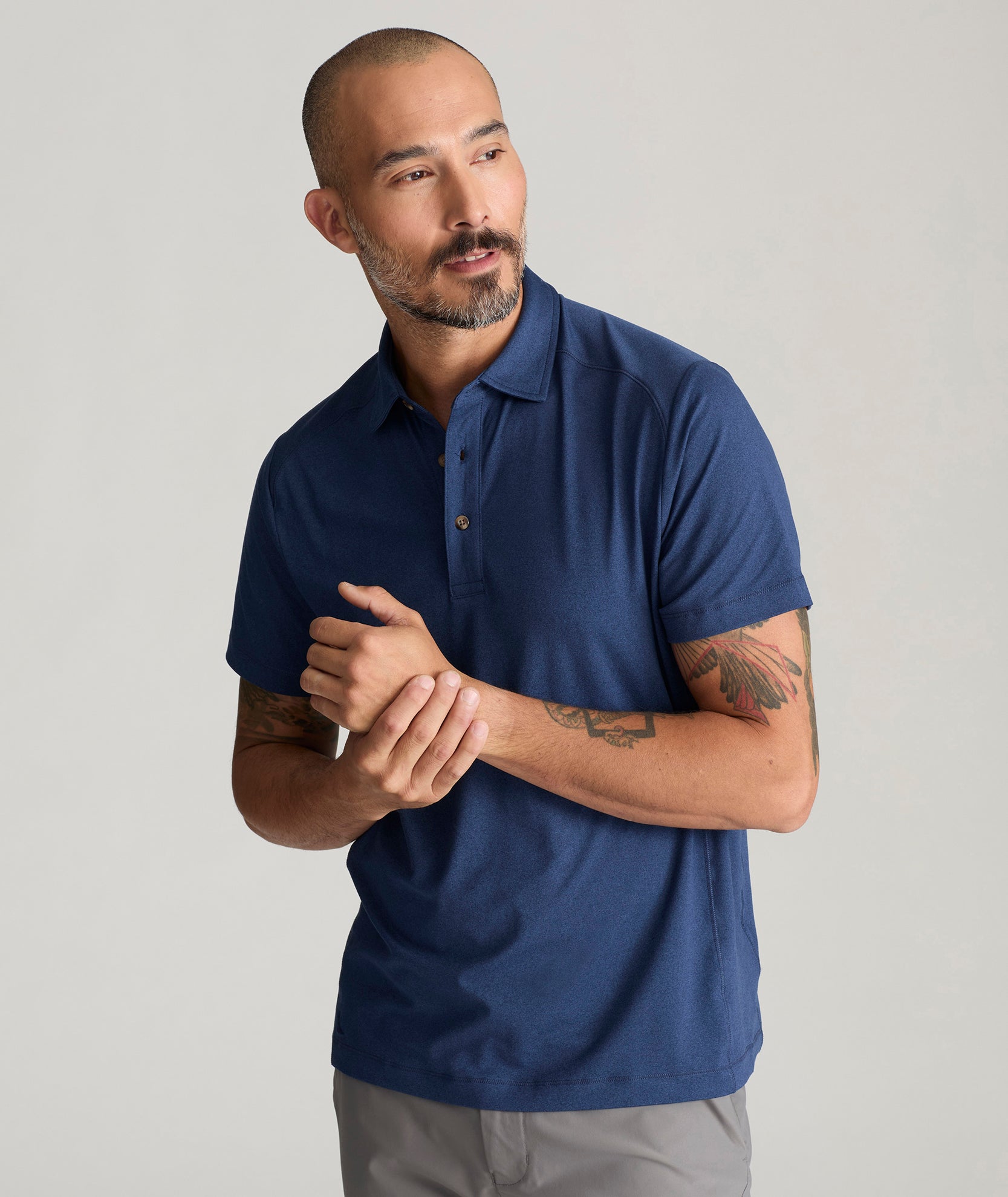 Model wearing a  Performance Polo in navy.