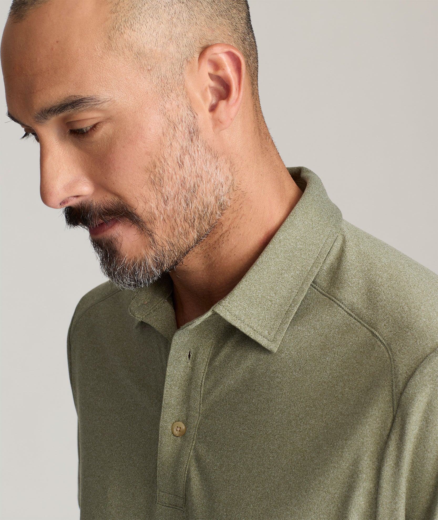 Model is wearing UNTUCKit Clavidor polo in olive.