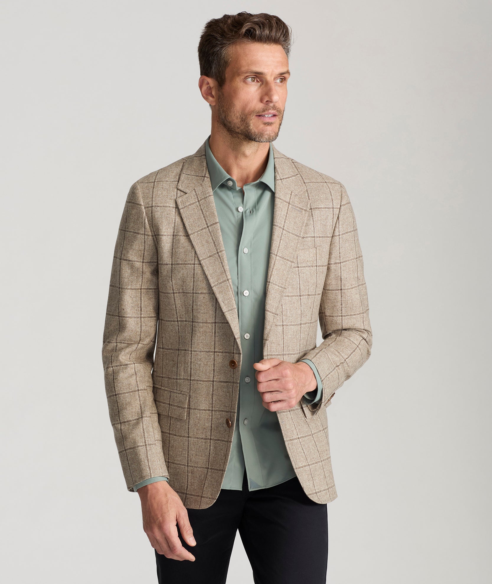 Model is wearing UNTICKit Italian Wool Blend Graydy Sport Coat in Tan Windowpane Check. 