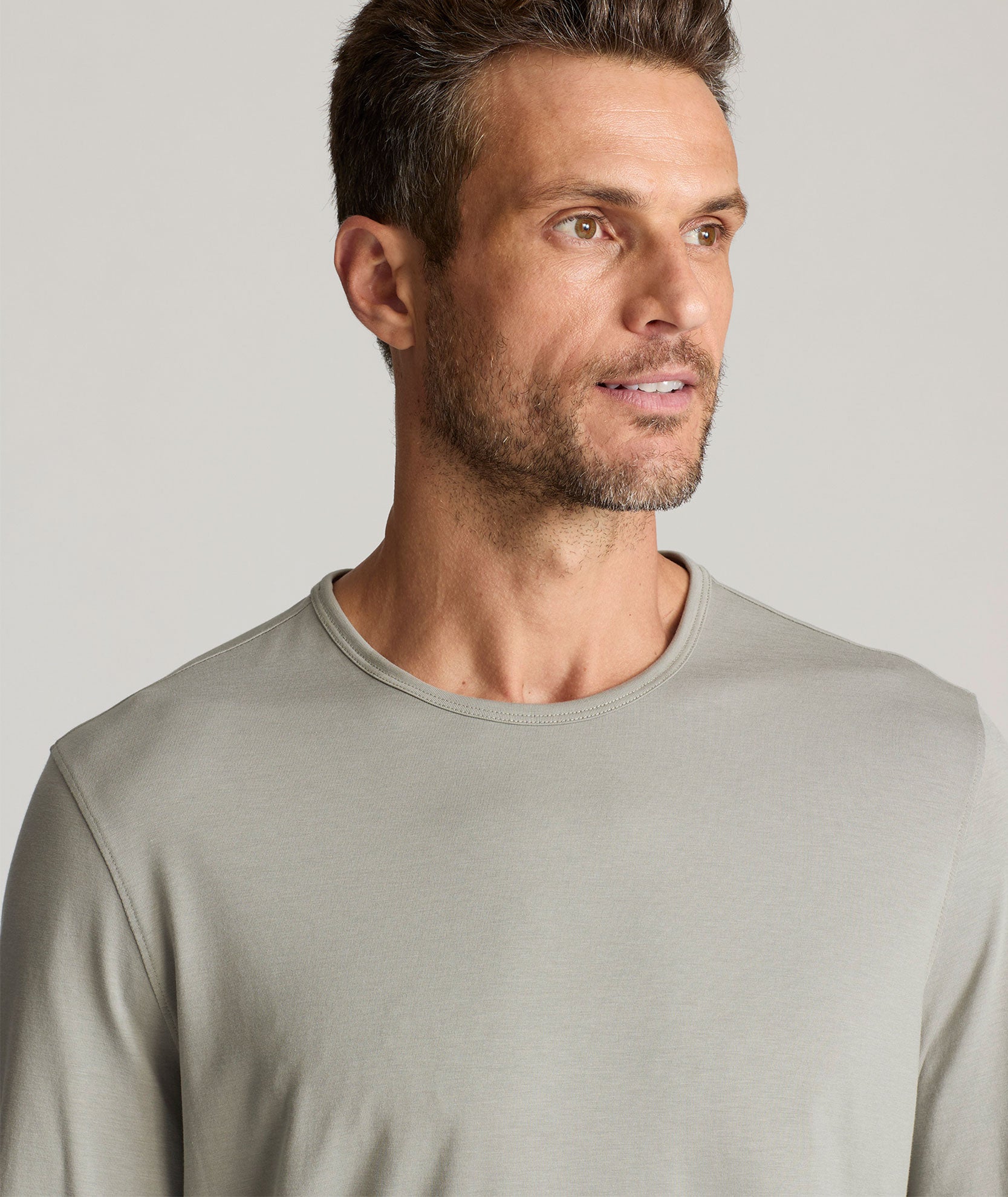 Model is wearing UNTUCKIt Merille long sleeve Tencel Tee in Military Green.