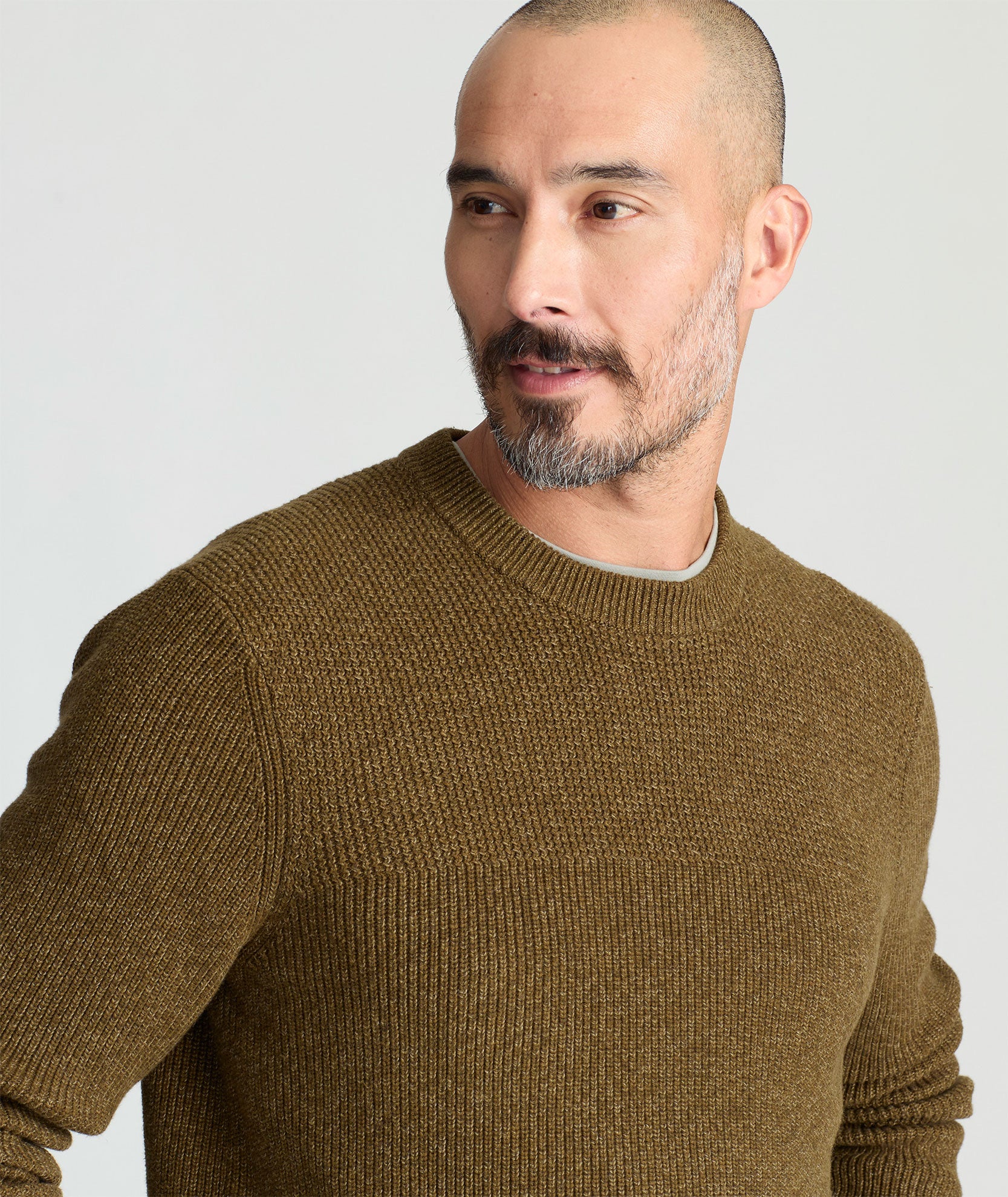 Model is wearing UNTUCKit Seaver Textured Crewneck in Dark Olive.