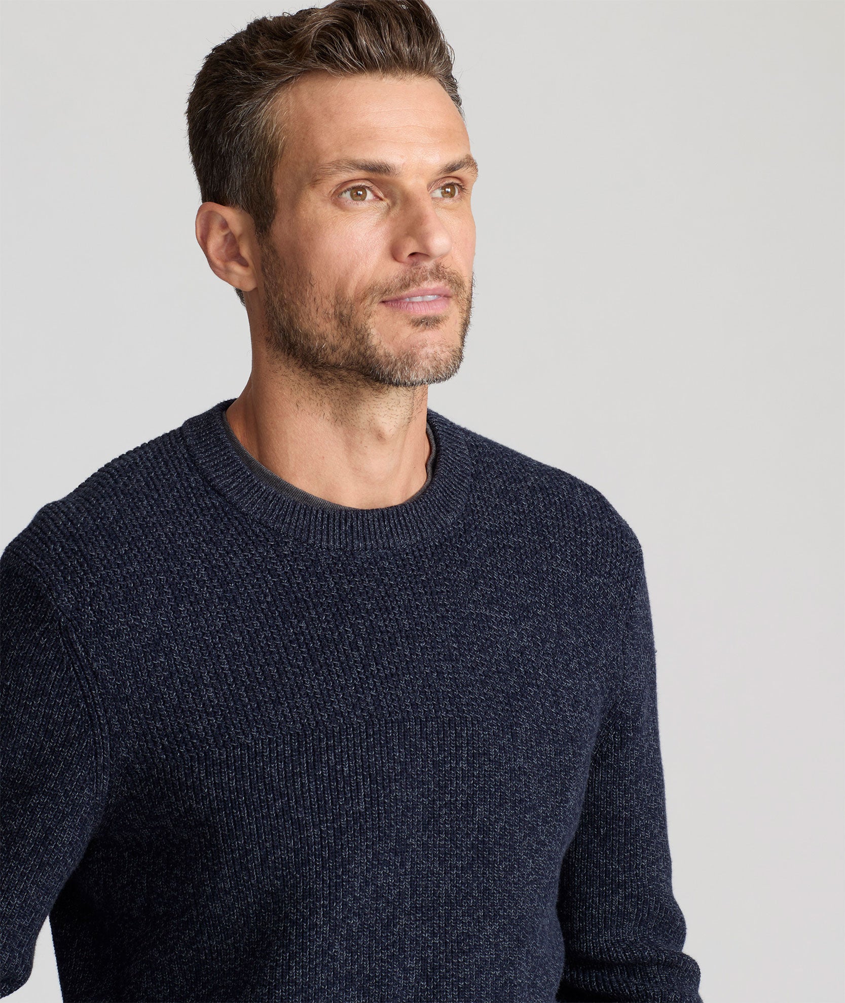 Model is wearing UNTUCKit Seaver Textured Crewneck in Sky Captain.