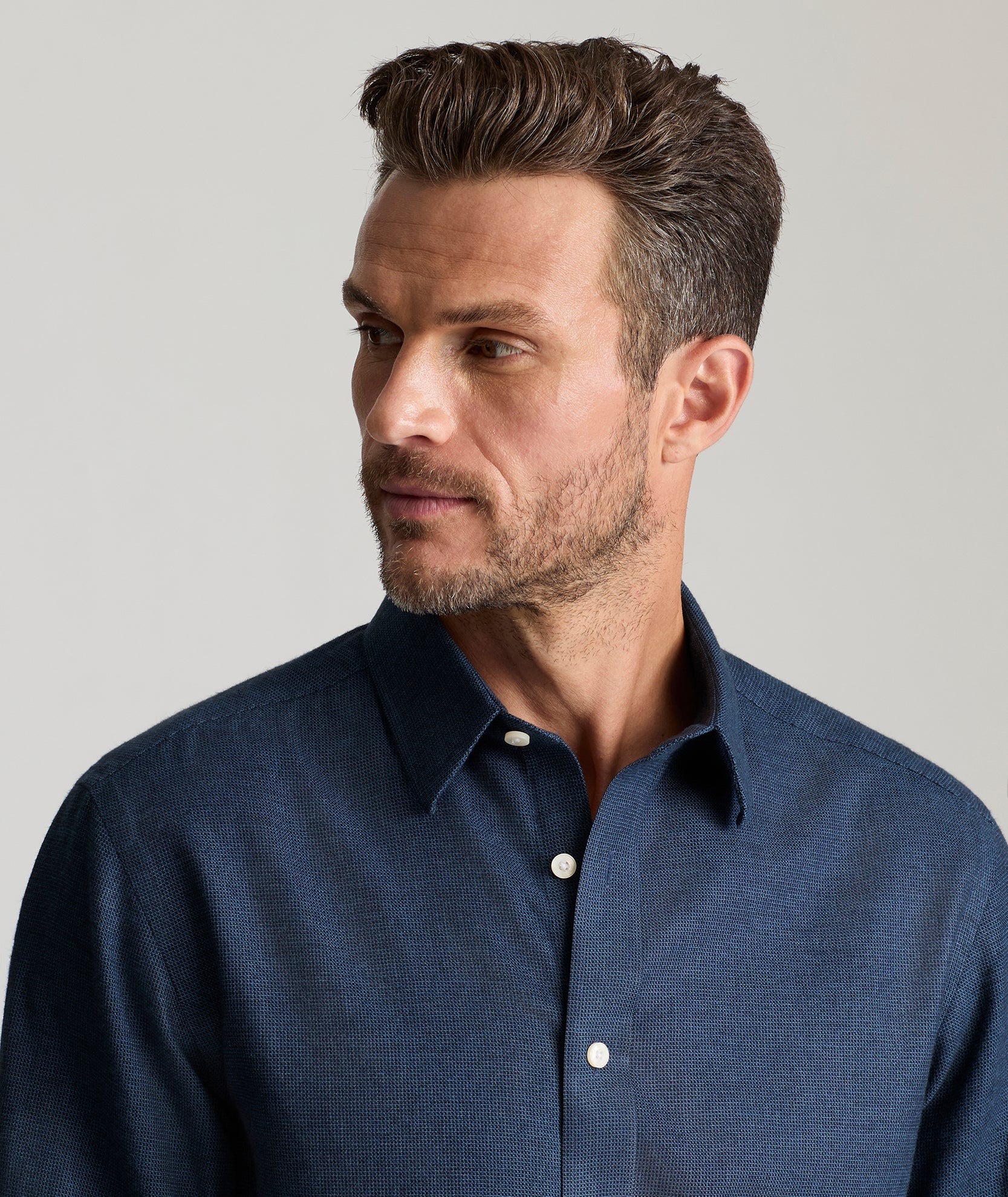 Model is wearing UNTUCKit Veneto shirt in teal.