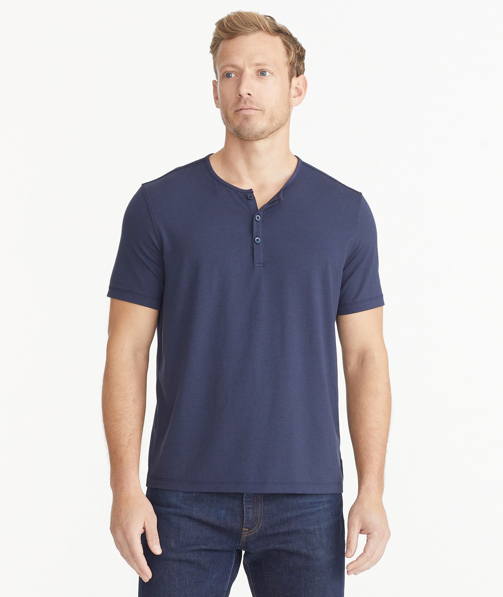 Model wearing an UNTUCKit Navy Essential Henley in EcoSoft™.