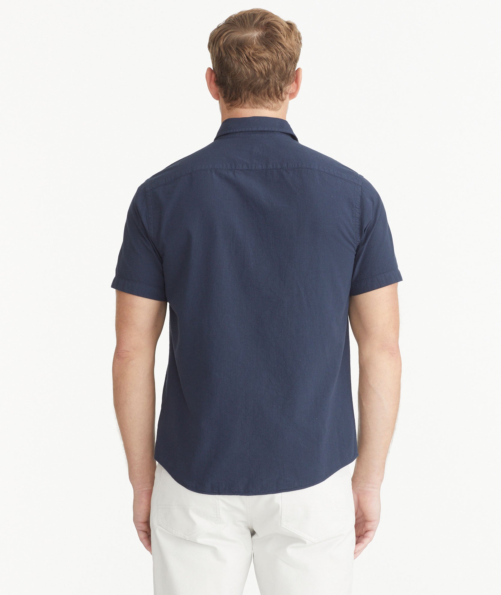 Model is wearing UNTUCKit Navy Cotton Seersucker Short-Sleeve Pavao Shirt.